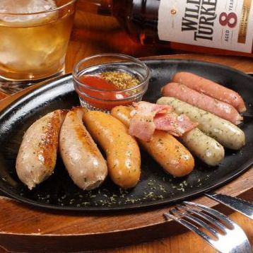 Mixed beer sausages grilled on a hot plate