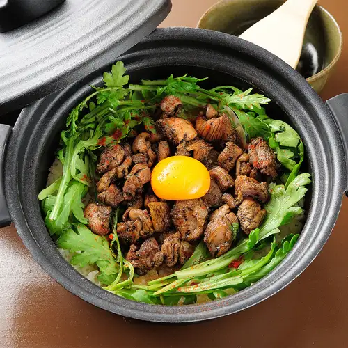 Classic clay pot rice with grilled chicken and egg yolk