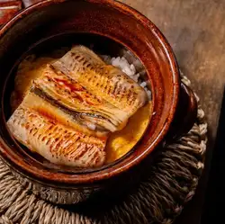 Clay pot rice with boiled conger eel from Tsushima and rolled omelet.