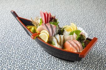5 pieces of sashimi on a boat