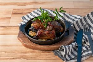 Bone-in premium pork grilled in a wood-fired oven