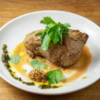 Roasted pork shoulder with spice and herb sauce