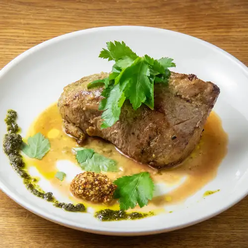 Roasted pork shoulder with spice and herb sauce