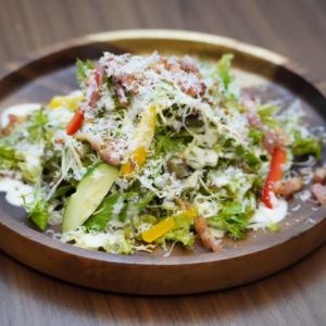 Caesar salad with grilled raw bacon