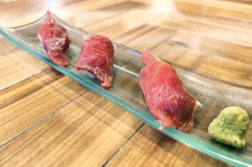 Three pieces of horse meat sushi