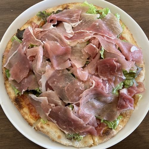 Pizza with prosciutto and green salad