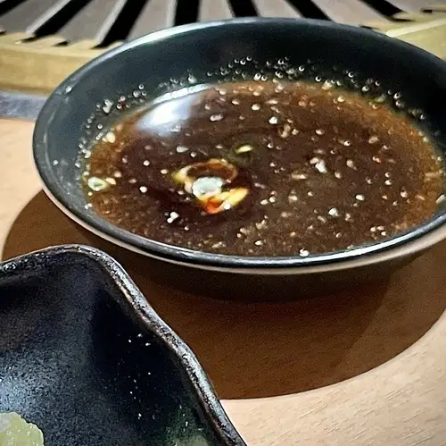 The sauce is homemade soy sauce-based sauce.