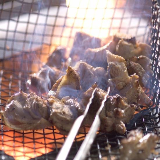 The chicken is grilled over charcoal and drips with condensed umami juices...