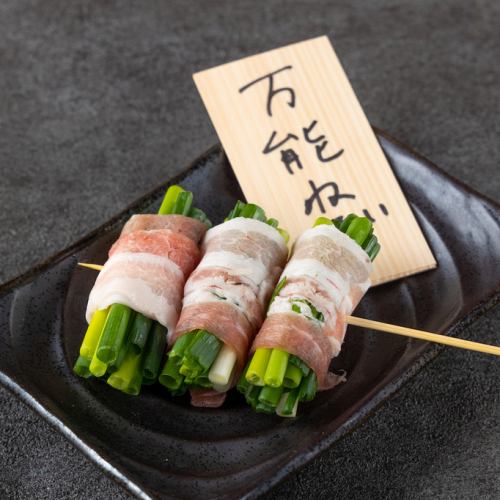 Charcoal-grilled skewered green onions