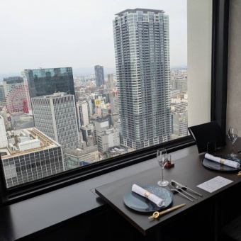 【窓際カップルシート】最上階33階からの景色を眺めながらお食事を堪能できます。デートや記念日のお祝いにオススメです。※チャージ1000円/名