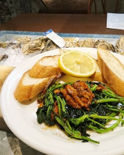 Sauteed oysters and kale with sea urchin butter