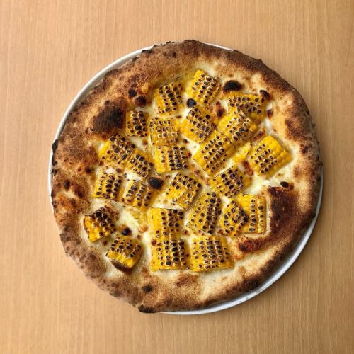Yellow pizza covered with corn
