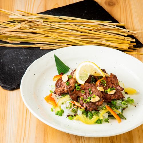 Pork tongue grilled over straw