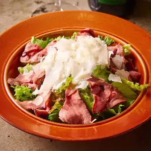 Homemade roast beef with green salad and citrus herb dressing