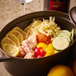 Young chicken and chunky vegetables in a spicy tomato and lemon STAUB pot.