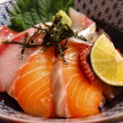 Bowl of rice topped with sashimi