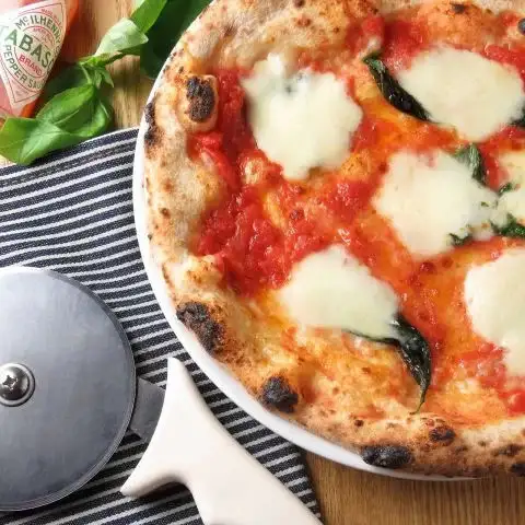 Our signature dish, Margherita pizza.
