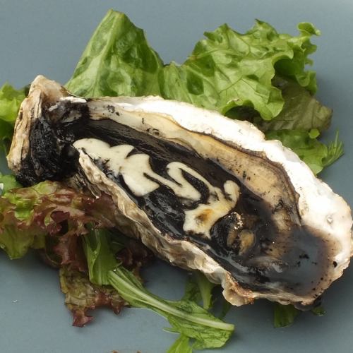 Grilled oysters with squid ink sauce