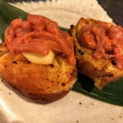 Potatoes topped with butter and salted fish