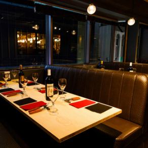 開放感あふれる一面の大きな窓が特徴の店内は、明るく広々とした空間。カジュアルなテーブル席で気軽にステーキとワインを楽しめる雰囲気です。