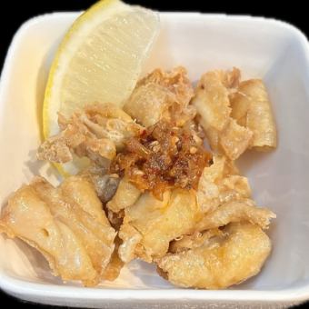 Crispy chicken skin topped with chili oil