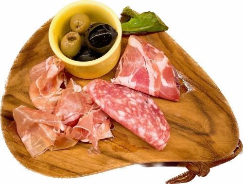 Assorted raw ham and olives