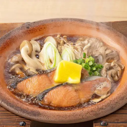 Grilled autumn salmon and mushrooms on a ceramic plate