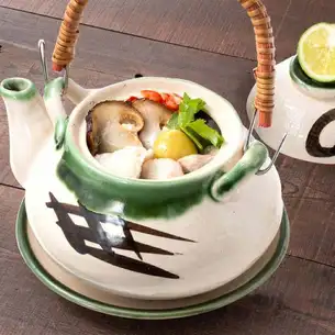 Matsutake mushrooms in a clay pot