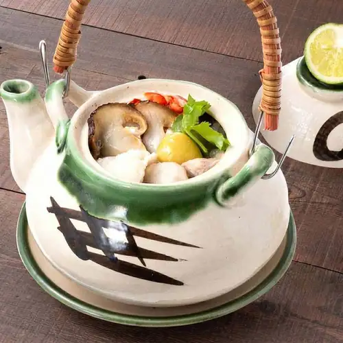 Matsutake mushrooms in a clay pot