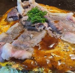 Hiroshima-style okonomiyaki, meat ball soba noodles, topped with koune meat