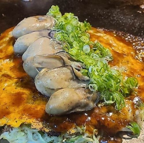Hiroshima-style okonomiyaki, meat and egg soba noodles, topped with oysters