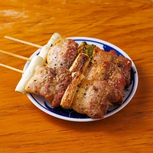 Pork and green onion skewers