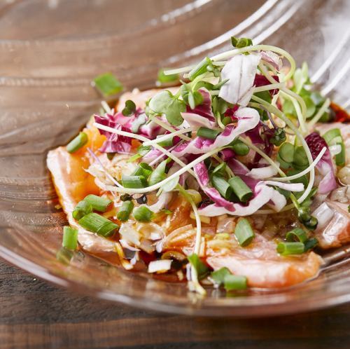 Salmon carpaccio with green onions and peanut oil