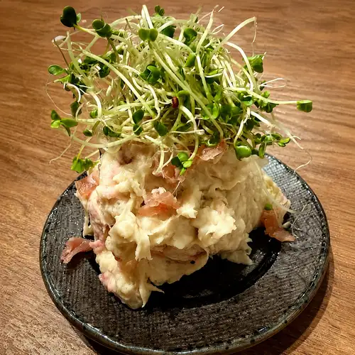 Rich potato salad with taro and prosciutto