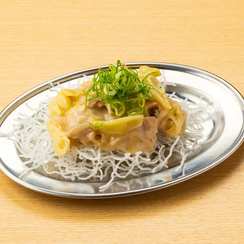 Deep-fried vermicelli noodles in a thick, white broth sauce.