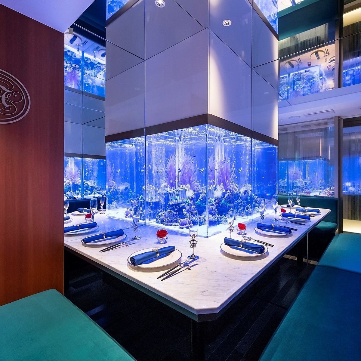 A complete private room that is healed by a large cobalt blue aquarium that feels like you are in the sea