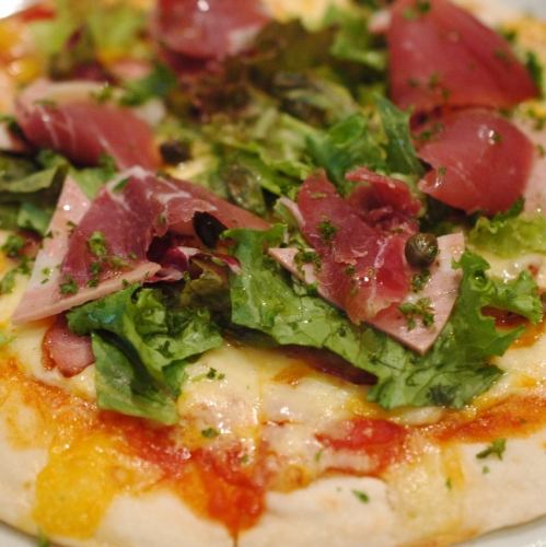 Pizza with raw ham and sausage