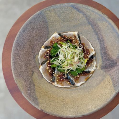 Carpaccio of wild sea bream from Chiba Prefecture with a sauce of charred leeks and sansho pepper.