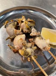 Grilled whelk skewers