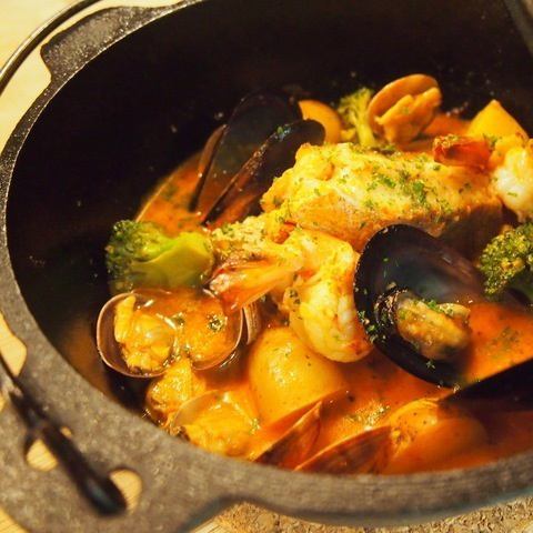 Iron pot bouillabaisse with lots of seafood