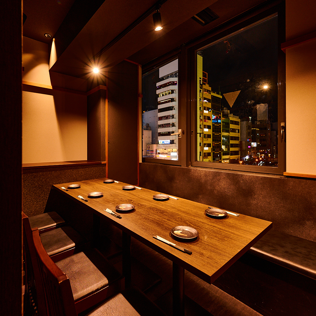 A spacious and relaxing private room with a sophisticated atmosphere enhanced by indirect lighting.