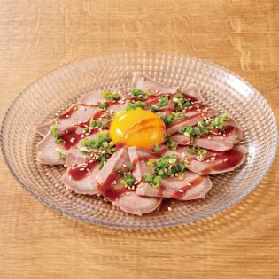 Thinly sliced pork tongue topped with egg yolk