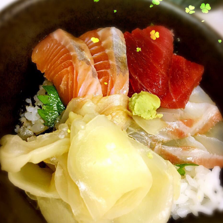 Bowl of rice topped with sashimi