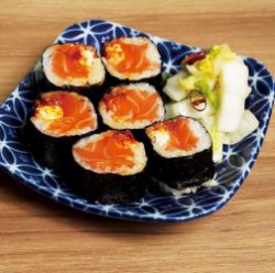 Sake accompaniment sushi roll with salmon, cream cheese and Cajun sauce