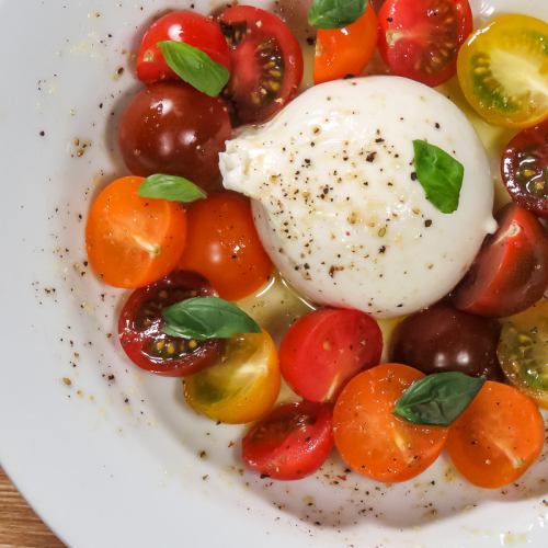 Caprese with colorful tomatoes and burrata cheese