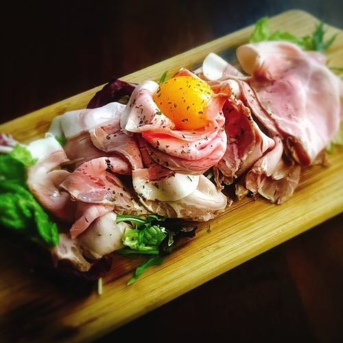 Specially selected domestic pork shoulder loin with homemade raw bacon, served with egg yolk