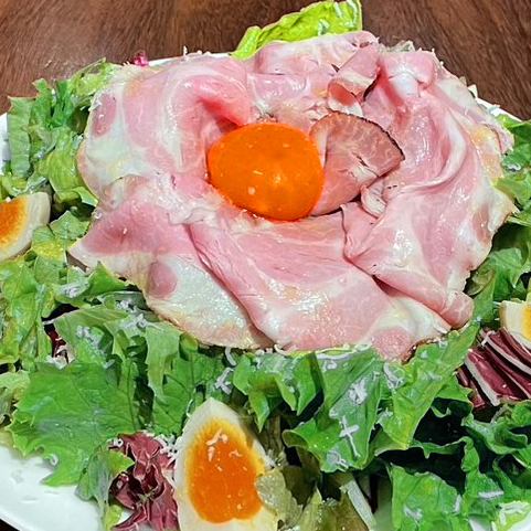 Special Caesar salad with raw bacon and smoked egg