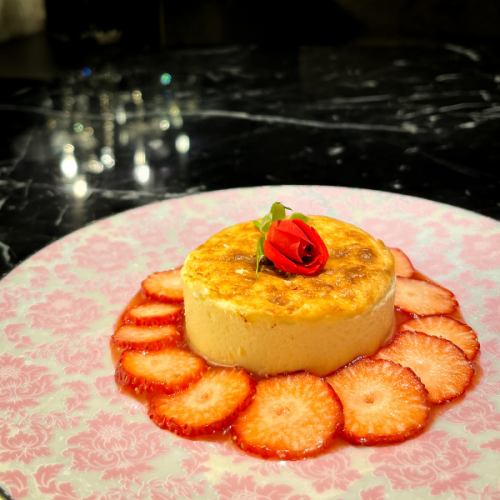 Basque-style cheesecake with strawberry sauce