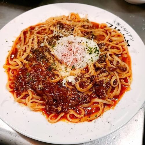 Fresh pasta with meat sauce topped with warm egg