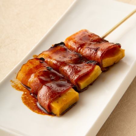 Namafu wrapped in bacon skewers